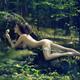 Beautiful nude woman lying on rocks in the nature bathing naked in sun... (thumbnail)