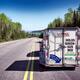 Car with a rental U-Haul cargo trailer on a road... (thumbnail)