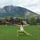 Woman practicing yoga in a park in Canmore Alberta... (thumbnail)