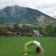 Woman doing bridge yoga posture in a park in Canmore Alberta... (thumbnail)