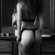 Back of a woman in underwear dressing up Black and white... (thumbnail)