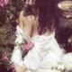 Artistic portrait of a beautiful woman in wet clothes sitting in rose... (thumbnail)
