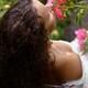 Sensual portrait of a woman smelling roses in a garden in the rain... (thumbnail)