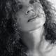 Natural beauty portrait of curly long hair covering young woman face B... (thumbnail)