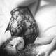 Sensual boudoir black and white portrait of a smiling young woman lyin... (thumbnail)