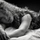 Sensual candid black and white portrait of a young beautiful woman lyi... (thumbnail)