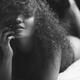 Woman lying in bed with her hair covering her face Sensual artistic bl... (thumbnail)