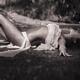 Beautiful sexy young woman in beach wear lying on the ground under pou... (thumbnail)