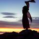 Woman in red dress flying in the wind dancing silhouette in sunset nat... (thumbnail)