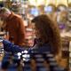 Woman at a grocery store looking at food products... (thumbnail)