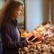 Woman picking fresh produce at a farm grocery store... (thumbnail)