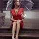 Woman in red dress sitting on the street with umbrella waiting for som... (thumbnail)