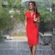 Woman in red dress with umbrella walking in the rain on the street... (thumbnail)