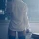 Back of sexy woman in mens shirt and stockings looking out of the wind... (thumbnail)