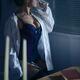 Beautiful sexy woman in a men's shirt on top of a corset sitting... (thumbnail)