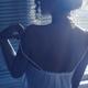 Back of sexy woman undressing by the window taking her night shirt off... (thumbnail)