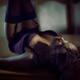 Sexy woman lying on dining table in corset and stockings in dark room... (thumbnail)