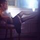 Woman sitting in chair by the window half undressed with her legs in s... (thumbnail)