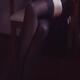 Closeup of sexy legs in black stockings of woman sitting in a chair... (thumbnail)