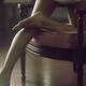Bare legs of a young woman leaning on a chair... (thumbnail)