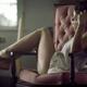 Sensual romantic portrait of young woman in night shirt sitting in arm... (thumbnail)