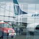 Fuel tanker track refueling WestJet airplane before flight at airport... (thumbnail)