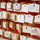 Ema wooden plaques with prayers and wishes hanging at Shinto shrine in... (thumbnail)