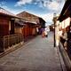 Couple with Japanese parasols in traditional kimono walking on street... (thumbnail)