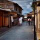 Rickshaw passing a Japanese couple wearing traditional kimono walking... (thumbnail)