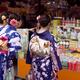 Japanese girls in bright Yukatas stopped by a shop with traditional lo... (thumbnail)
