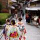 Girls in bright yukatas walking down an old street in Kyoto with artis... (thumbnail)