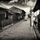 Couple with Japanese parasols in traditional kimono walking on street... (thumbnail)