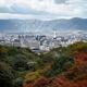 Kyoto tower with mountains and colorful autumn trees aerial city scene... (thumbnail)