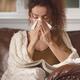 Woman got sick blowing her runny nose in paper tissue staying home... (thumbnail)