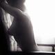 Artistic nude black and white portrait of woman sitting naked in armch... (thumbnail)