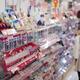 Woman looking at makeup display of Japanese beauty product store... (thumbnail)