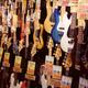 Electric guitars and bass guitars on display in a music store in Japan... (thumbnail)