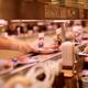 Closeup of a sushi chef placing a plate on a conveyor belt at Musashi... (thumbnail)