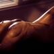 Art nude sexy woman lying with her naked body outline lit by dim night... (thumbnail)