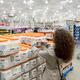 Woman picking a can of coconut oil at Costco Wholesale warehouse store... (thumbnail)