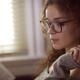 Woman in glasses reading a book by the window... (thumbnail)