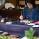 Japanese woman calligrapher writing at a desk... (thumbnail)