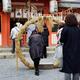 Woman stepping through a straw ring at a Japanese Shinto shrine for pu... (thumbnail)