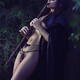 Artistic sensual portrait of a sexy Native American tribal woman playi... (thumbnail)