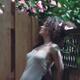 Tranquil sensual portrait of a beautiful woman under a pink camellia w... (thumbnail)