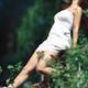 Young woman in white summer dress enjoying sunshine in a spring garden... (thumbnail)