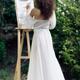 Beautiful woman artist with an easel painting outdoors in a garden in... (thumbnail)