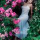 Romantic sensual woman in an elegant dress on the stairs in a garden a... (thumbnail)