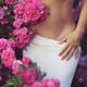 Sensual closeup of a woman half naked body in a rose garden behind pin... (thumbnail)