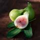 Organic freshly picked ripe Kadota figs on a fig leaf food still life... (thumbnail)